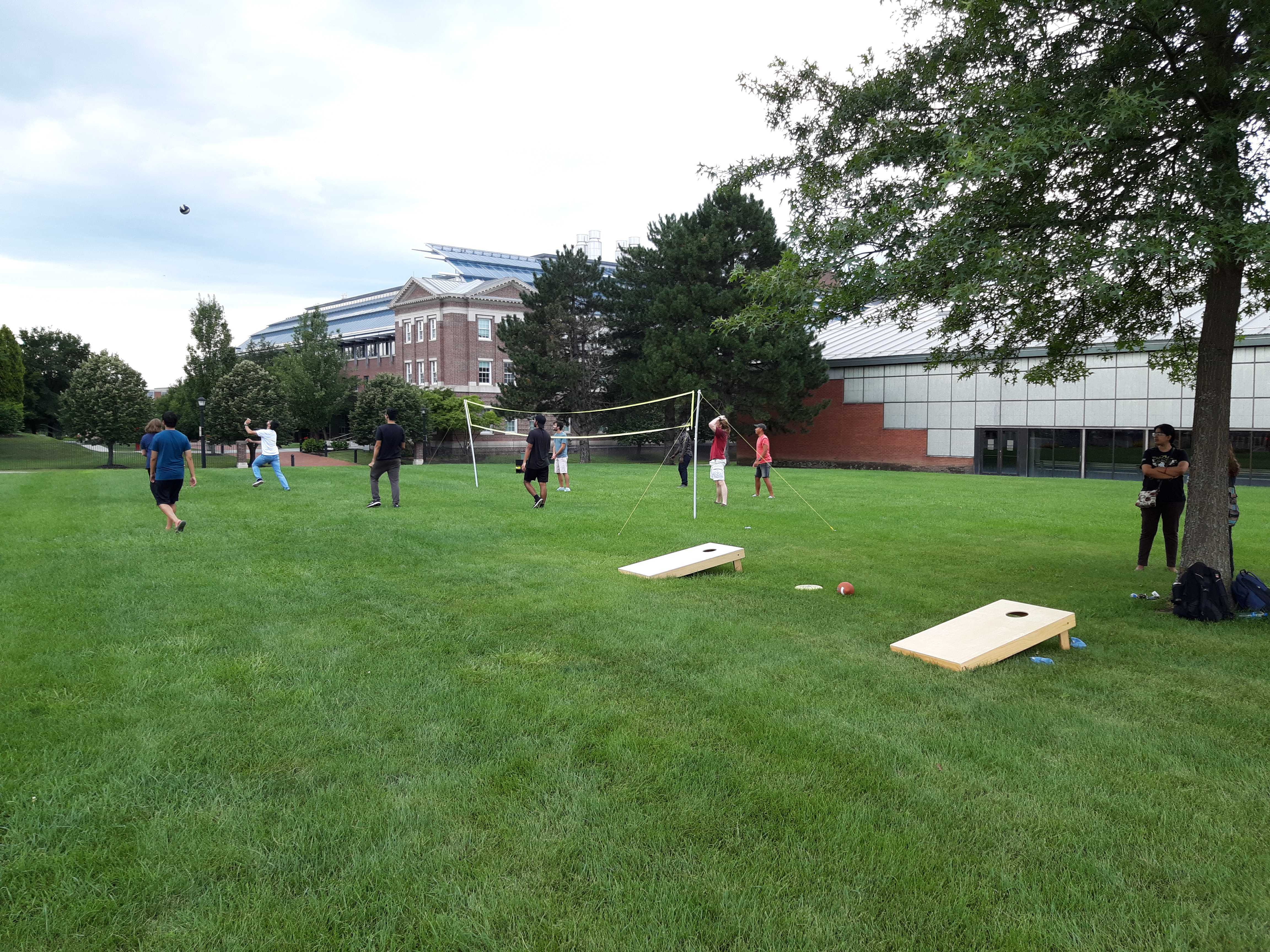 People playing volleyball on campus lawn