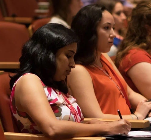Two students sitting in auditorium
