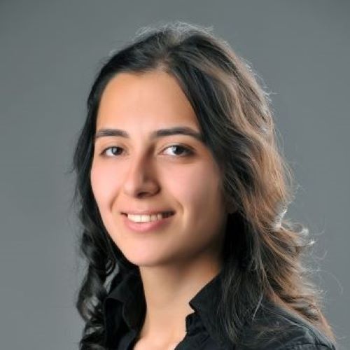 A young woman smiles at the camera