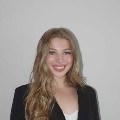 A young woman smiles at the camera