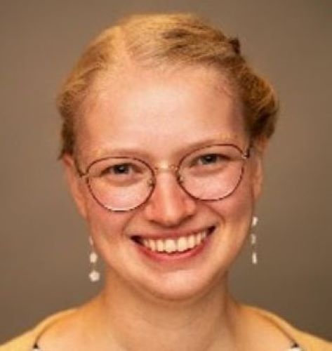 A young woman smiles at the camera