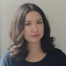 A headshot view of a young woman looking towards the photographer